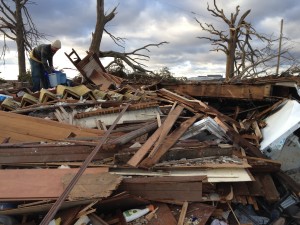 Ben sorting through wreckage of his home