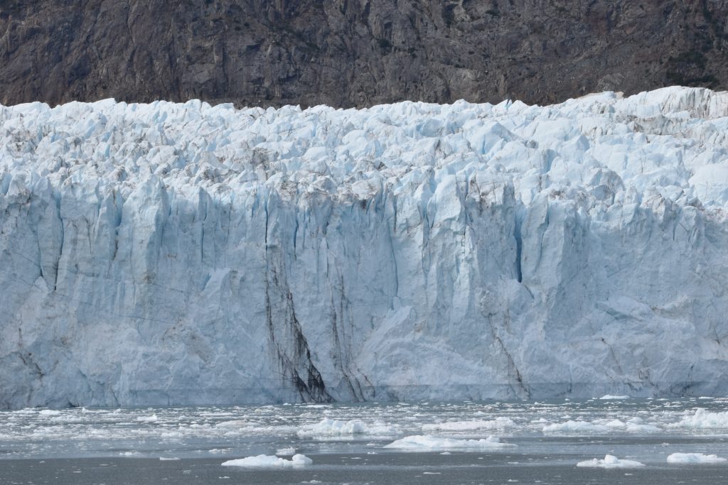 View of Margerie Glacier in Tarr Inlet. Ice has blue aspects. This glacier is floating on the sea surface and calves icebergs.