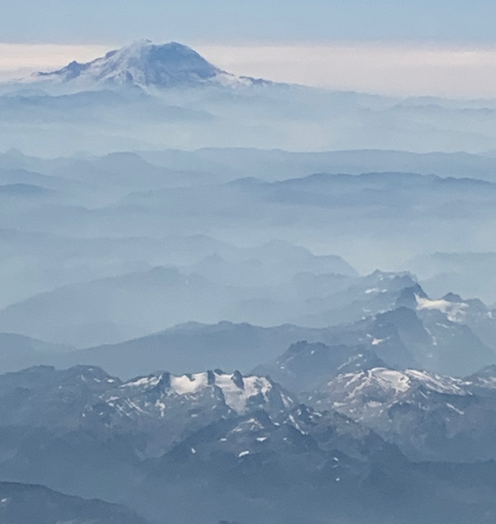 Mount Rainier viewed above the clouds in a plane