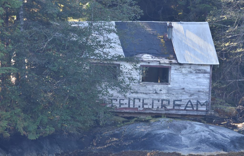 Abandoned building at Butedale Cannery with ice and ice cream painted on the side.