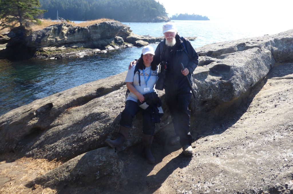 Ruth and Mark looking towards Seattle as they are near the edge of Sucia Island.