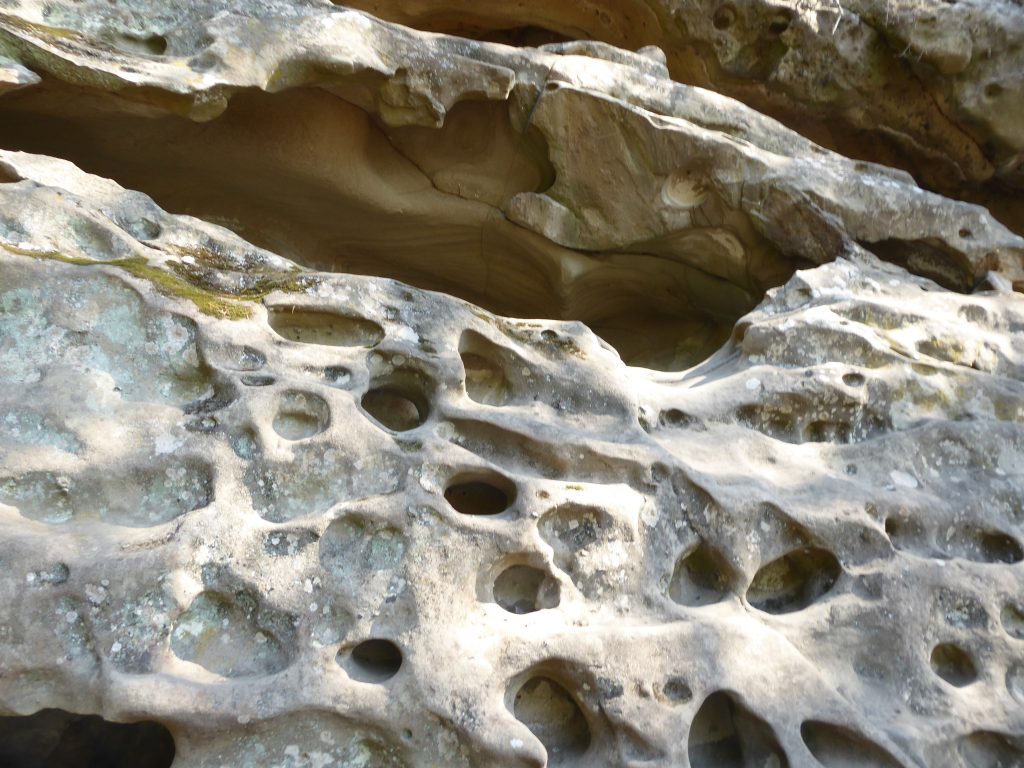 Sandstone pock marked with holes which can be used for hiding items and people.